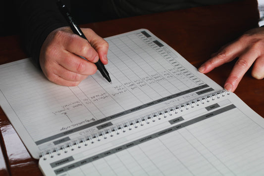 Photo: Sailor keeping a daily log in the Offshore Logbook