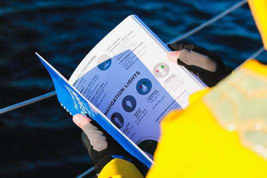 Sailor looking at a sailing logbook with navigation lights information