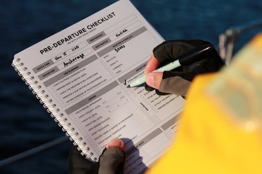 Photo: Sailor completing Pre-Departure Checklist in the All-weather Logbook