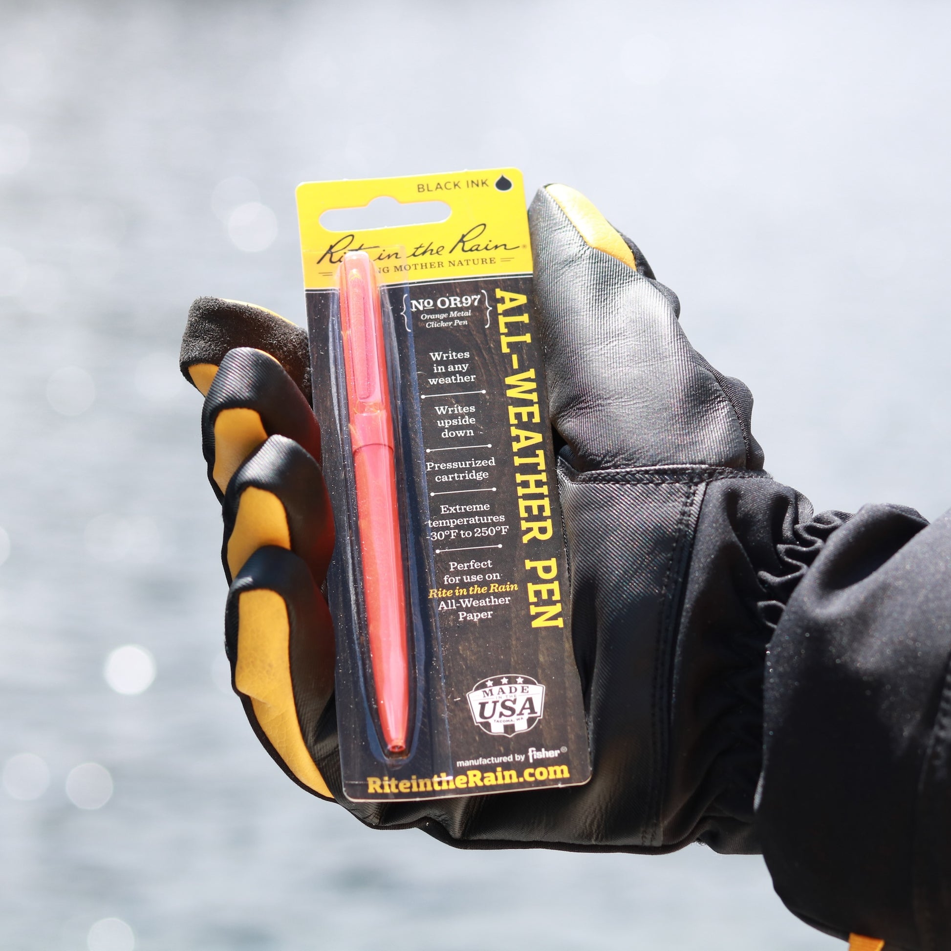 Photo: Sailor holding Rite in the Rain Orange Pen (Packaging)