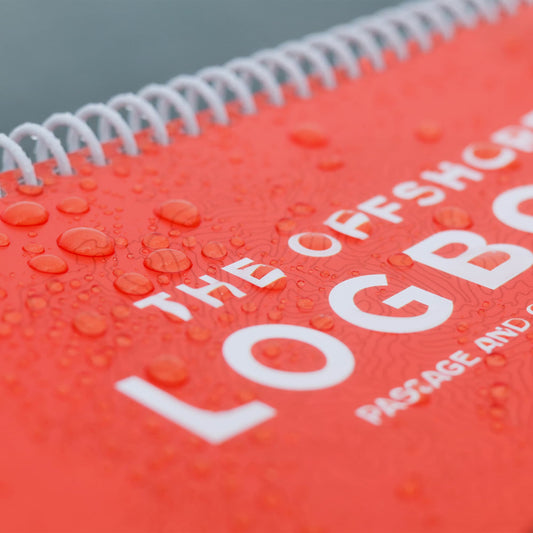 Water drops on waterproof cover of offshore sailing logbook.