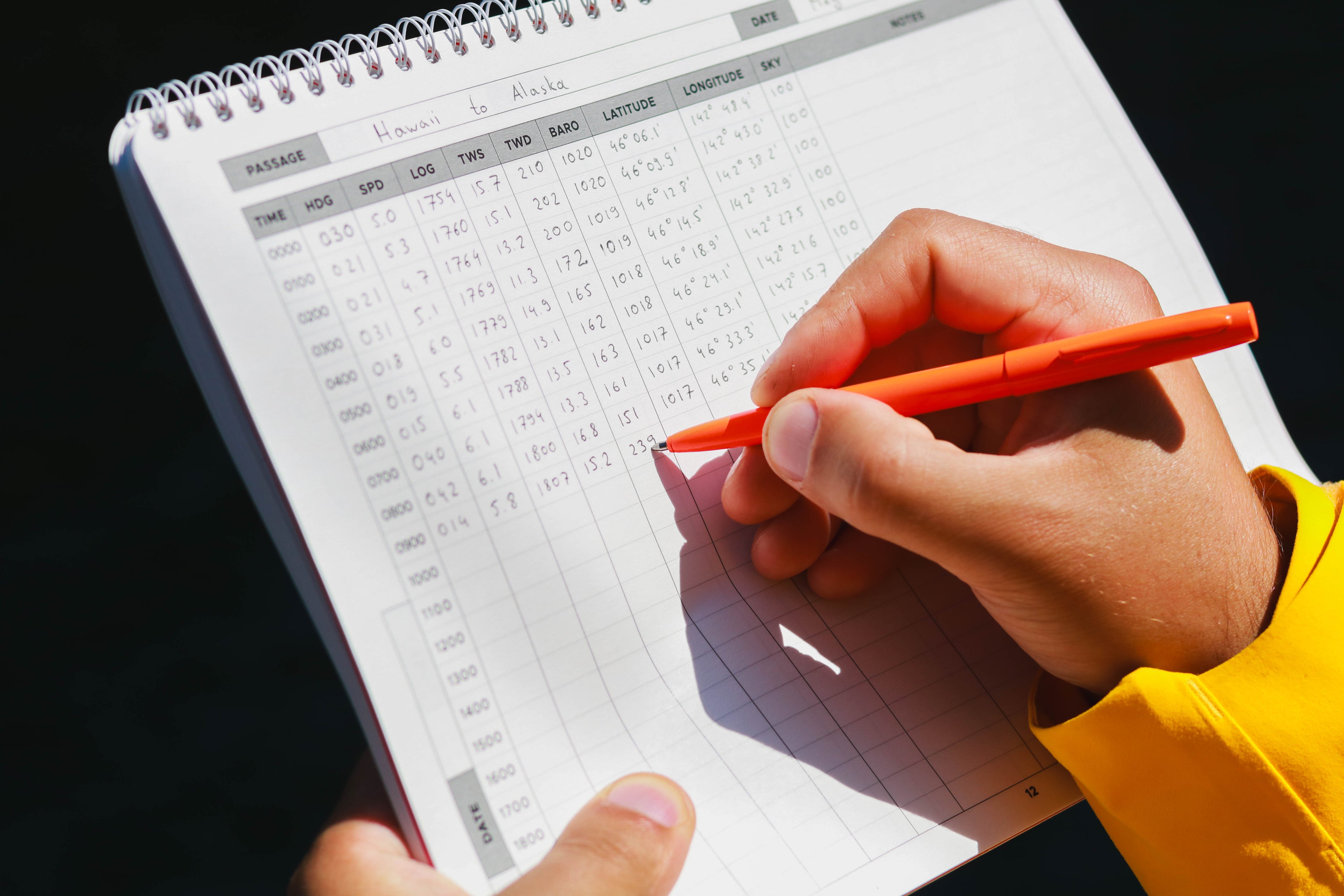 A sailor logging the data in the Offshore Sailing Logbook