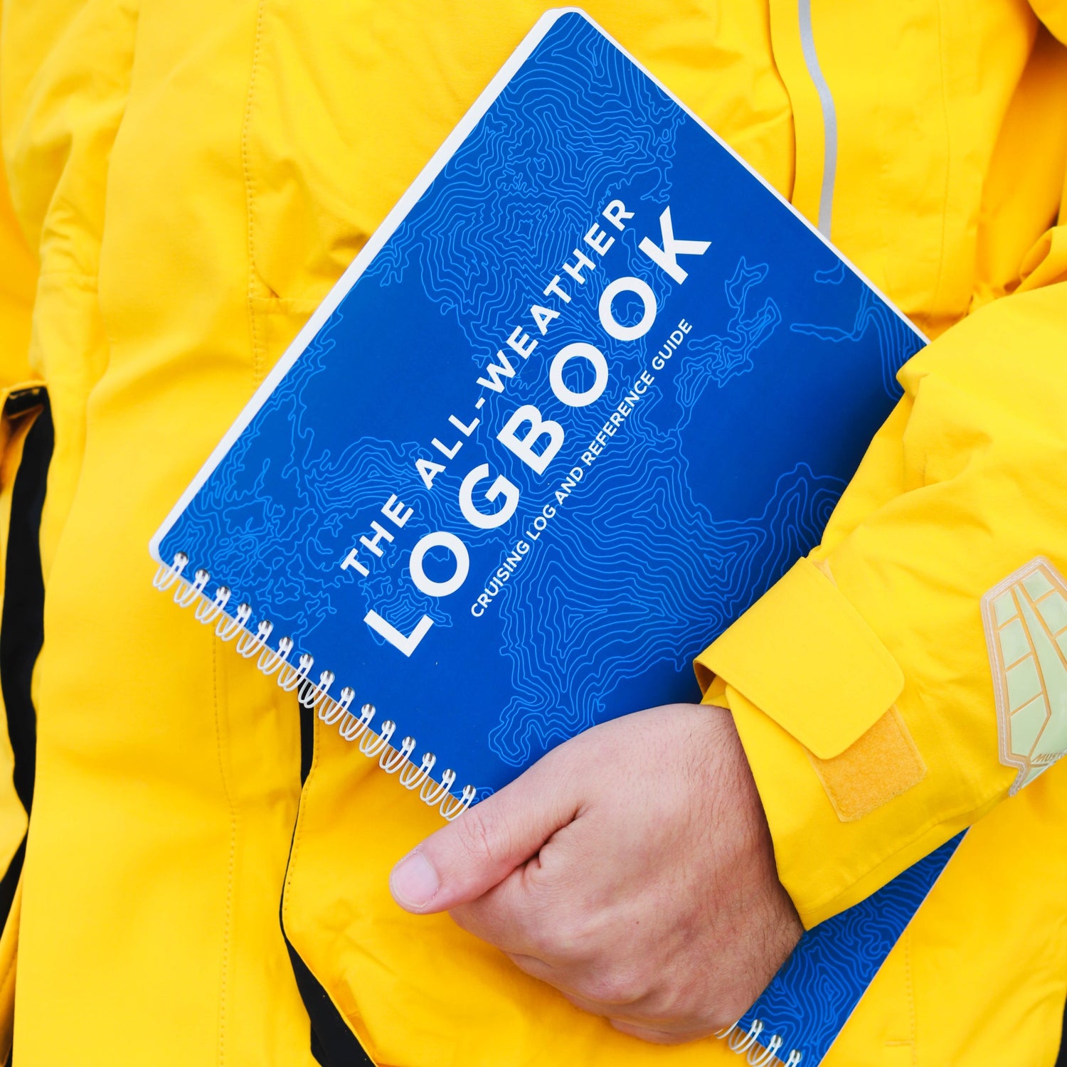 Photo: Mariner holding waterproof sailing logbook
