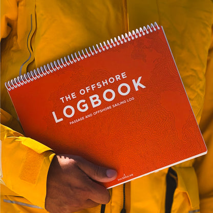 Sailor holding waterproof offshore sailing logbook