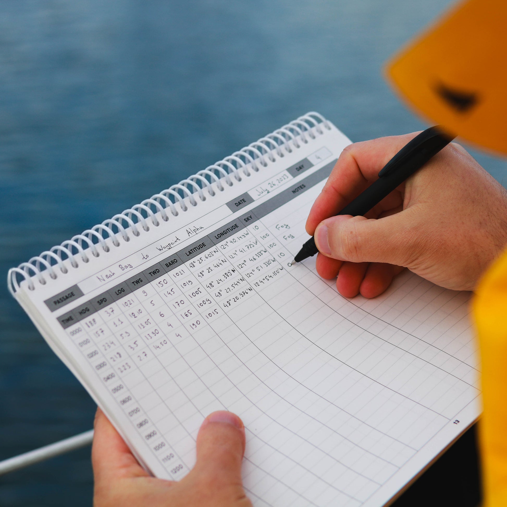 Mariner writing in offshore sailing logbook