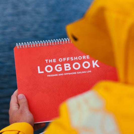 Offshore sailing logbook used during a 24-hour passage on deck.
