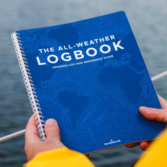 Photo: Sailor holding the all-weather sailing logbook